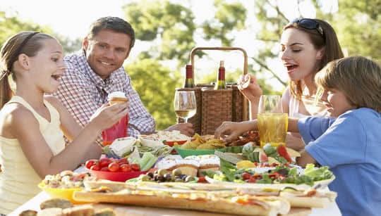 family eating while camping