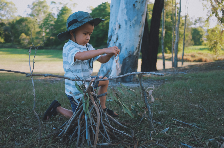 kid starting a campfire