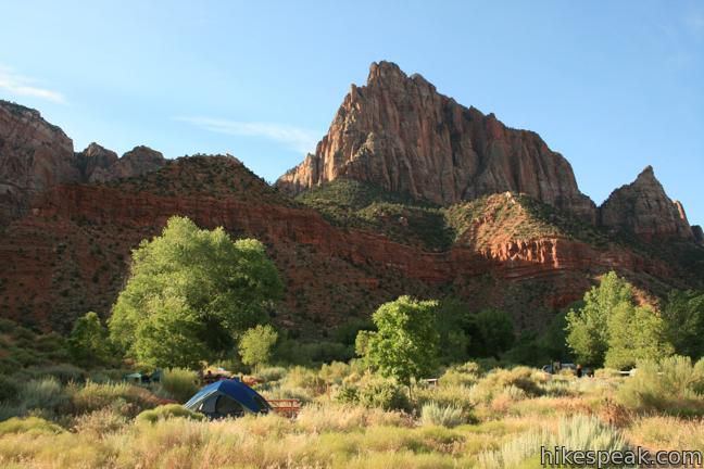 camping with tent and campfire and kayaks
