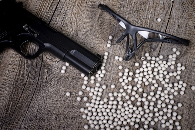 black airsoft gun with glasses and pellets