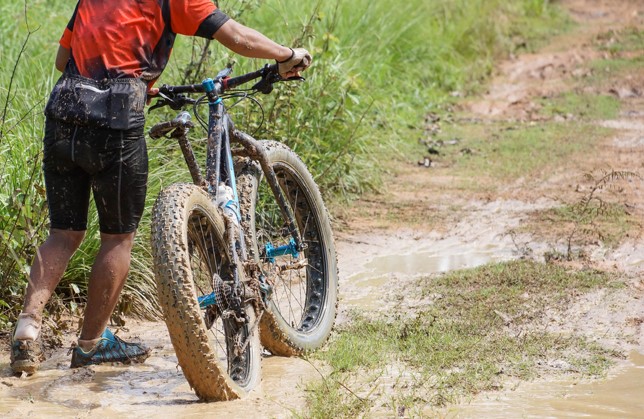 man pushing fat tire bike