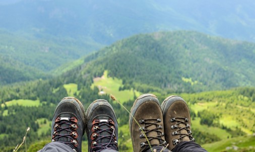 two people showing off their hiking boots
