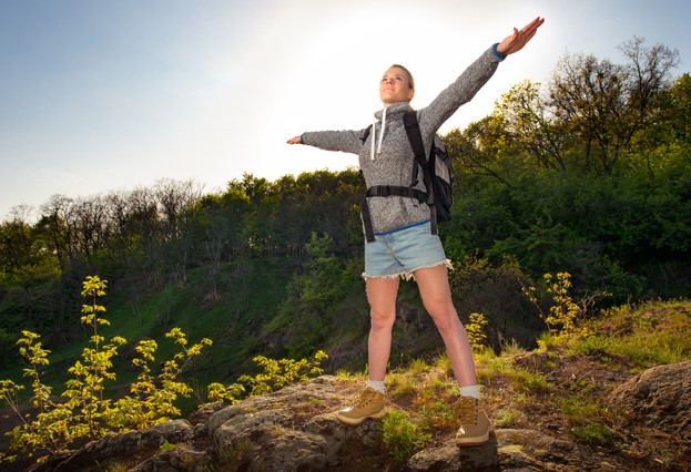 woman standing on top of a hill