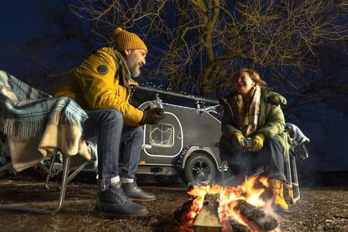 two people around a campfire