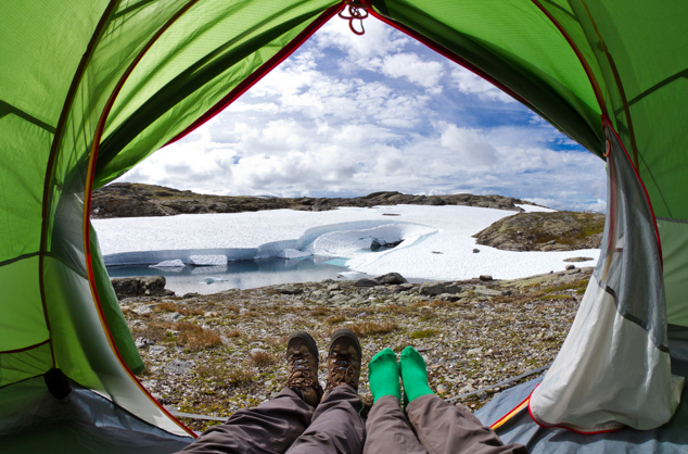 two people laying in a tent